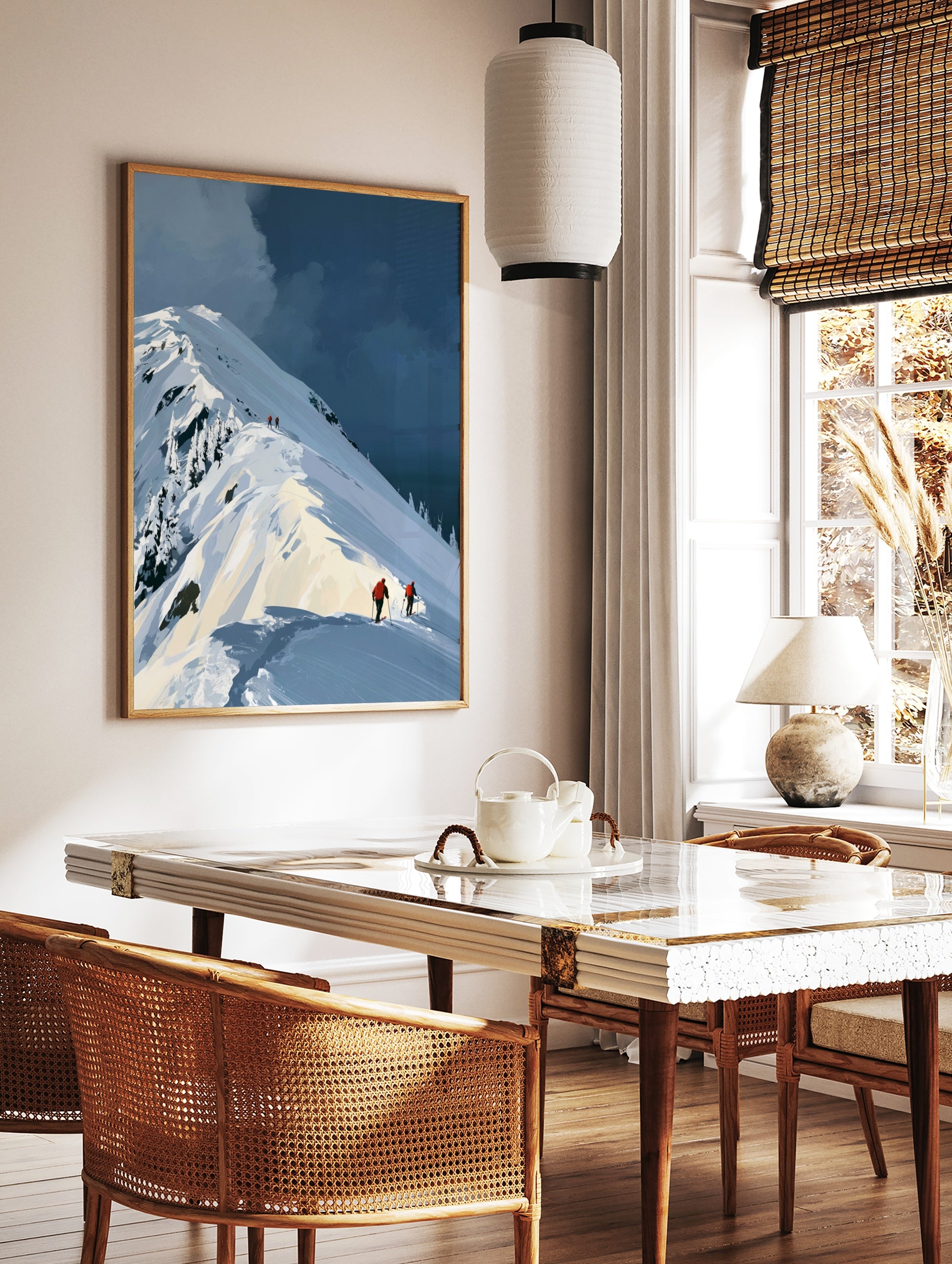 Illustrative mountain landscape art print featuring skiers in orange jackets on a snowy ridge under, in a styled room mockup