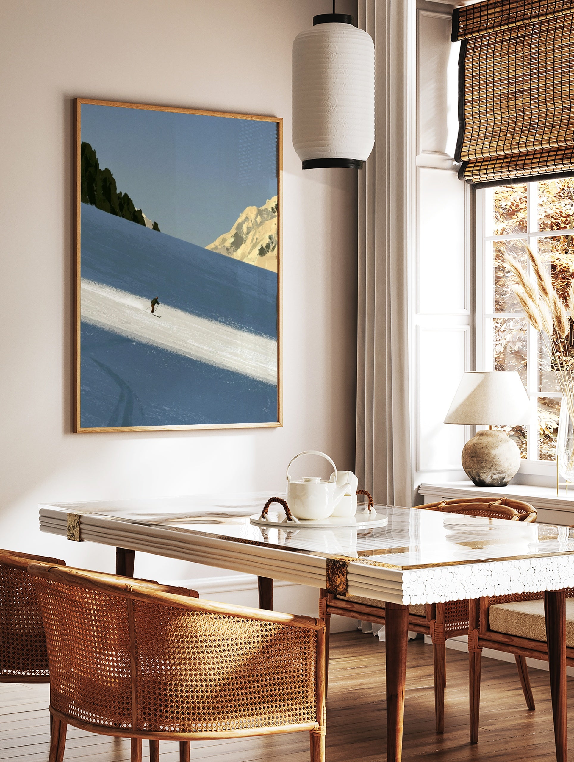 Minimalist skiing mountain wall art featuring a lone skier on a blue snowy slope with rocky peaks, in a styled room mockup