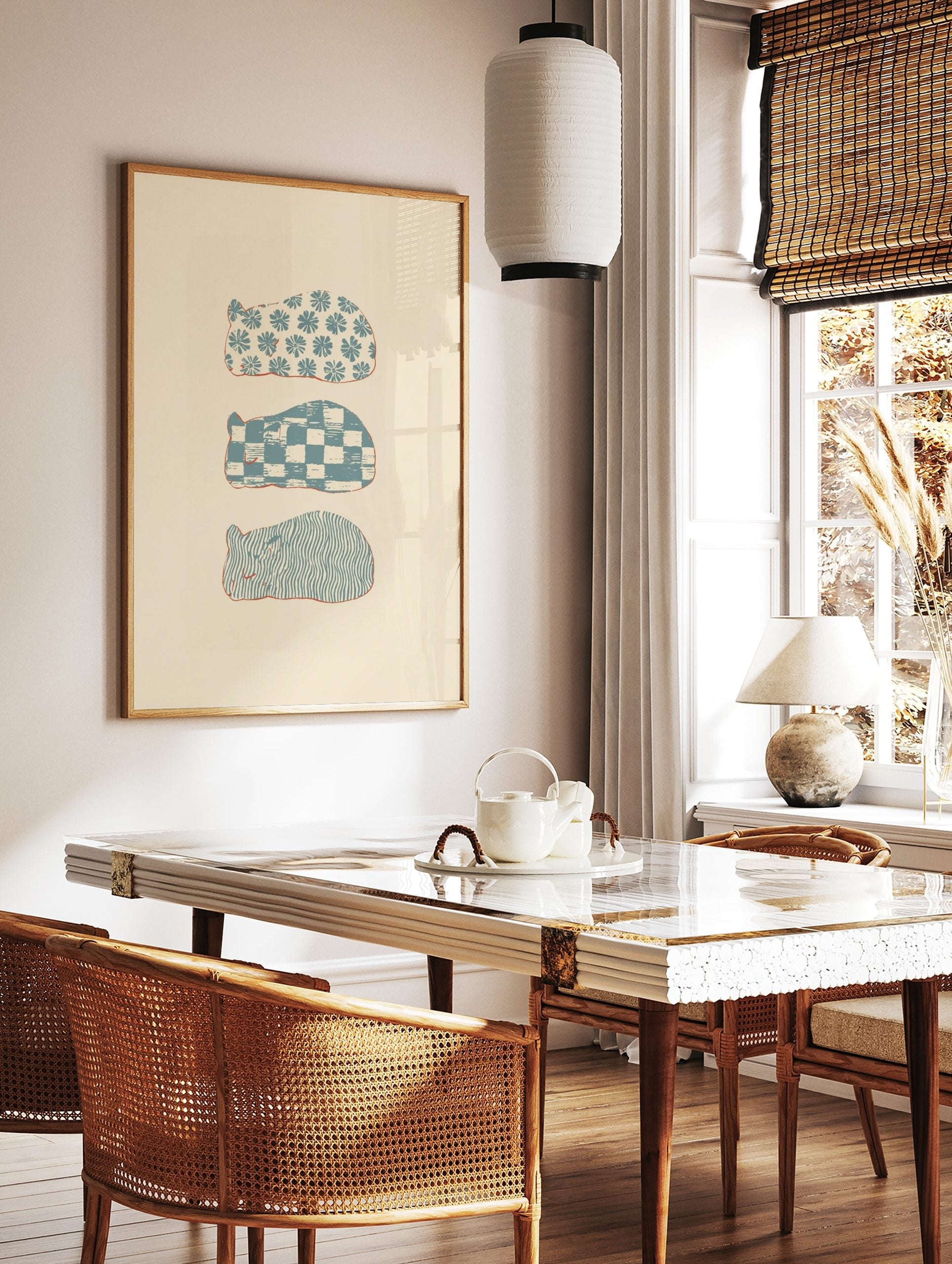 Three stylised sleeping animal shapes with blue floral, checkerboard, and wavy patterns on a cream, in a styled room mockup