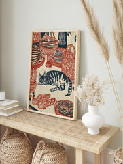 Woodblock style print featuring a sleeping cat surrounded by woven baskets of fish in red and, in an alternate framed mockup