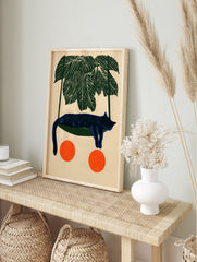 Illustrative blue cat sleeping in a green hammock under palm leaves with two orange circles, in an alternate framed mockup