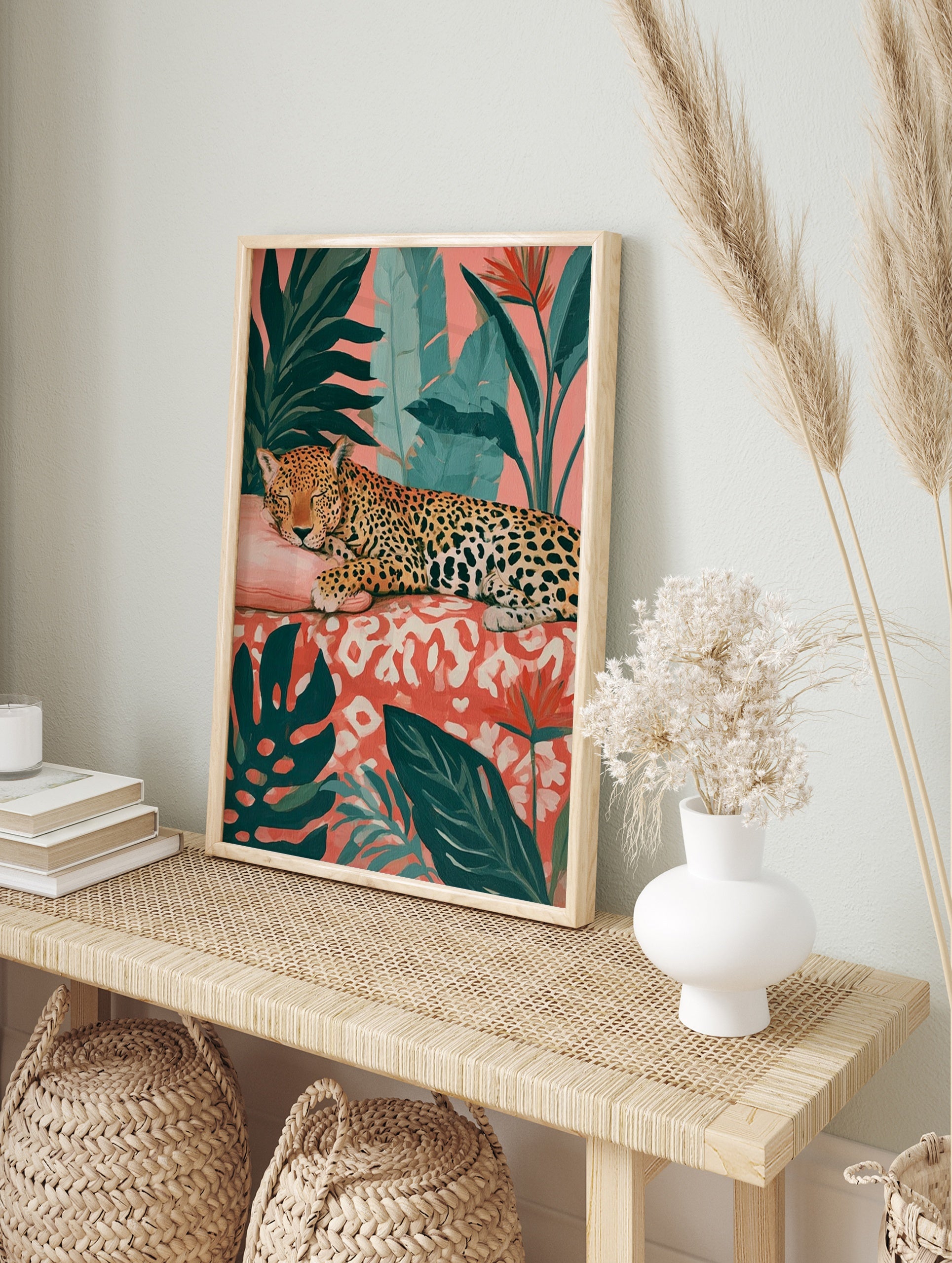 Sleeping leopard illustration with monstera leaves and bird of paradise flowers on a pink, in an alternate framed mockup
