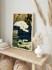 Illustration of a sleeping white polar bear on a deep blue blanket, with stacked books and, in an alternate framed mockup