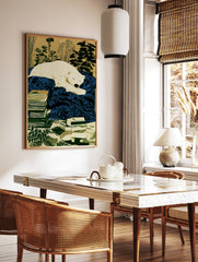 Illustration of a sleeping white polar bear on a deep blue blanket, with stacked books and plants, in a styled room mockup