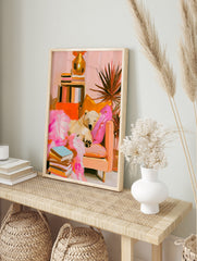 Impressionist style polar bear sleeping on a sofa with books and a houseplant, featuring pink, in an alternate framed mockup