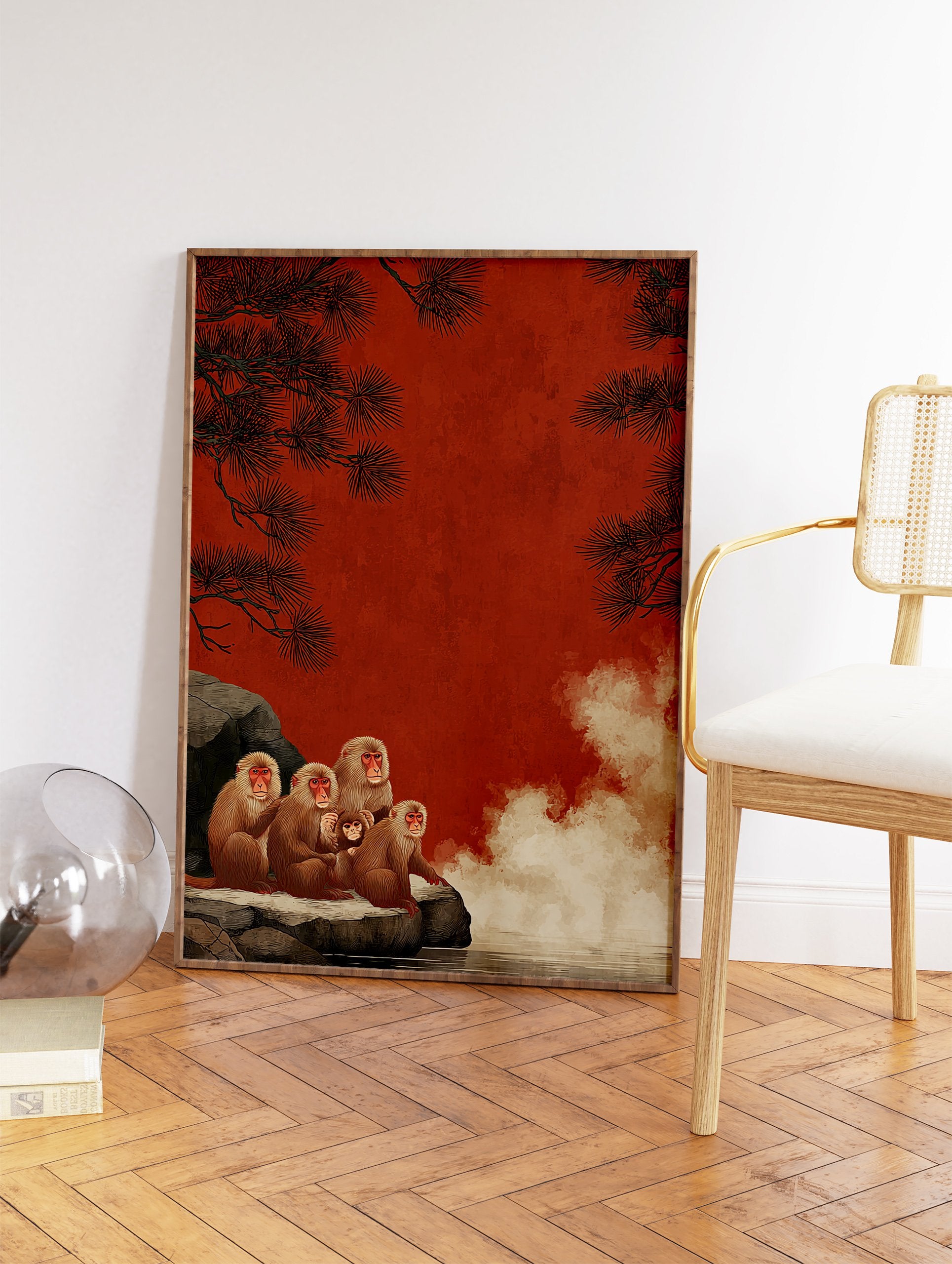 Snow monkey family, including a baby, sitting on rocks by a hot spring with pine trees and a red background. - Image 2