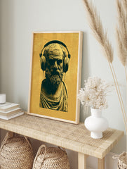 Classical bust of Socrates wearing modern headphones in a mustard and dark yellow, in an alternate framed mockup