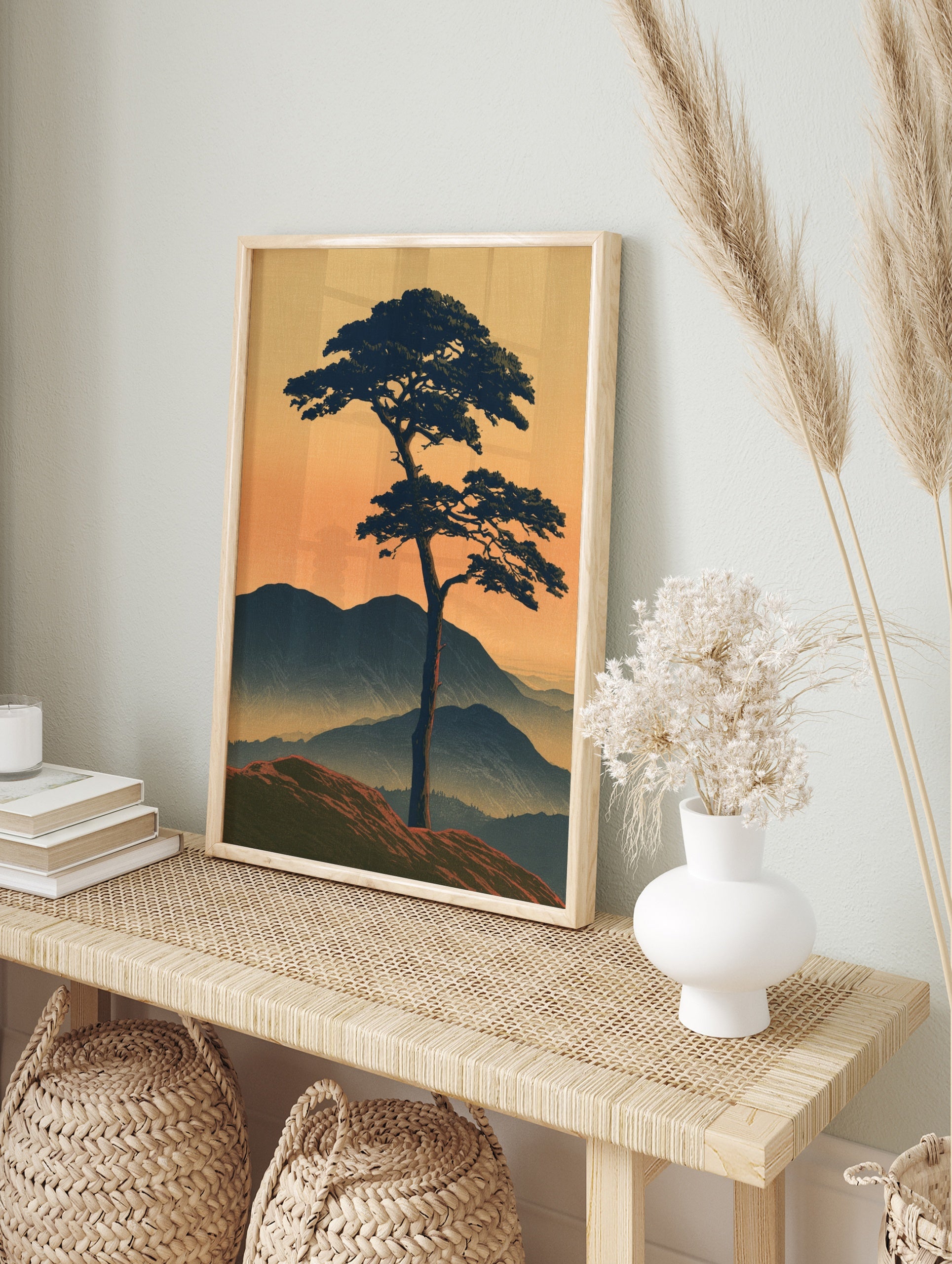 Japanese-style landscape print of a solitary pine tree on a ridge against misty mountains and, in an alternate framed mockup