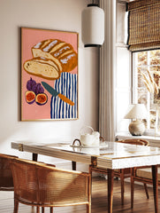 Illustrative art print of sliced sourdough bread, figs, and a striped tea towel on a pink background, in a styled room mockup