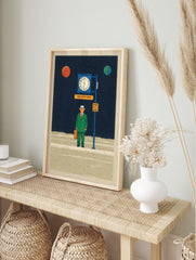 Surreal illustrative print of a man in green suit at a bus stop in space with planets and, in an alternate framed mockup