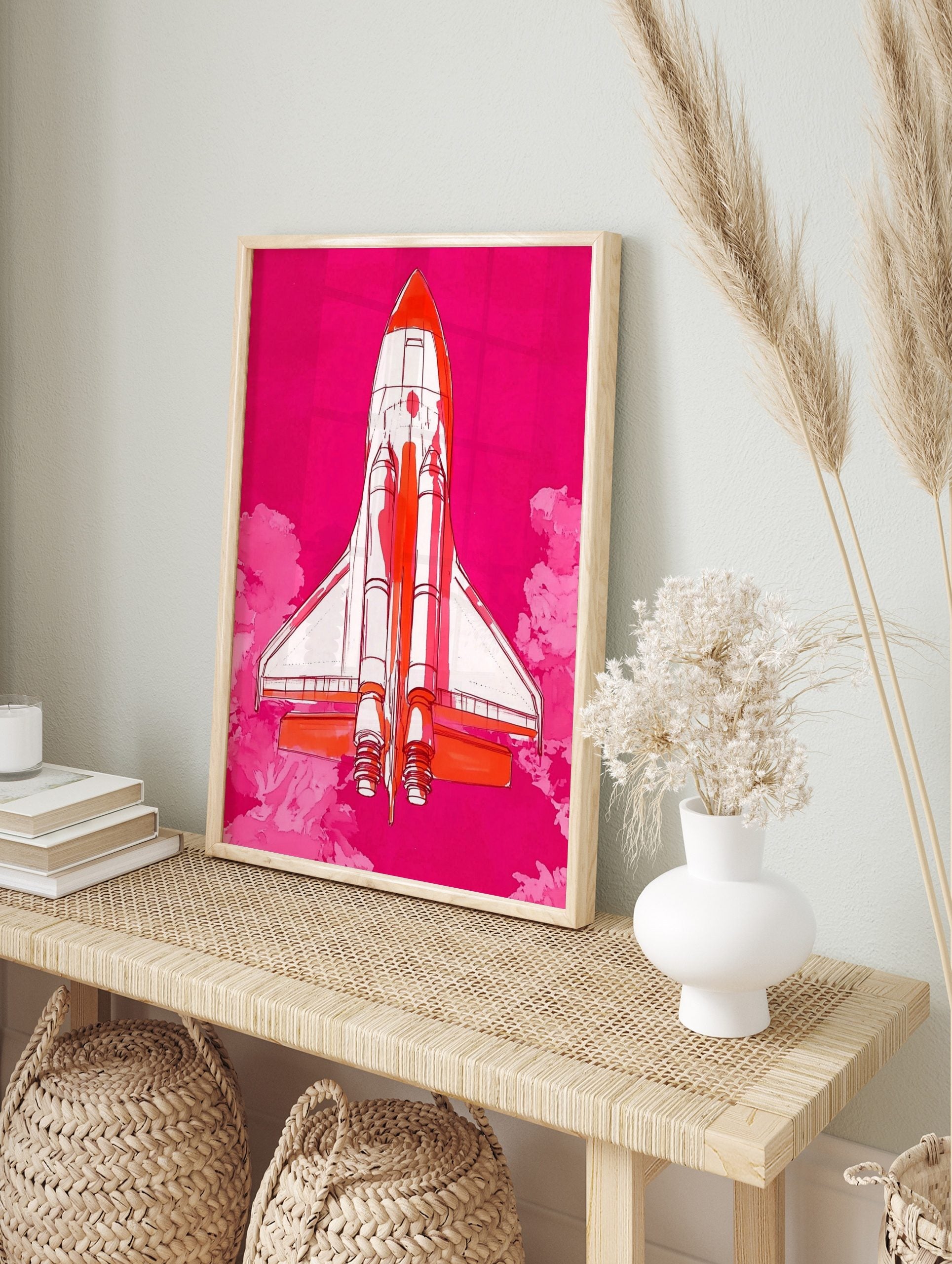Illustrative Space Shuttle rocket in white and orange against a vibrant pink sky with pink, in an alternate framed mockup