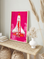 Illustrative Space Shuttle rocket in white and orange against a vibrant pink sky with pink, in an alternate framed mockup