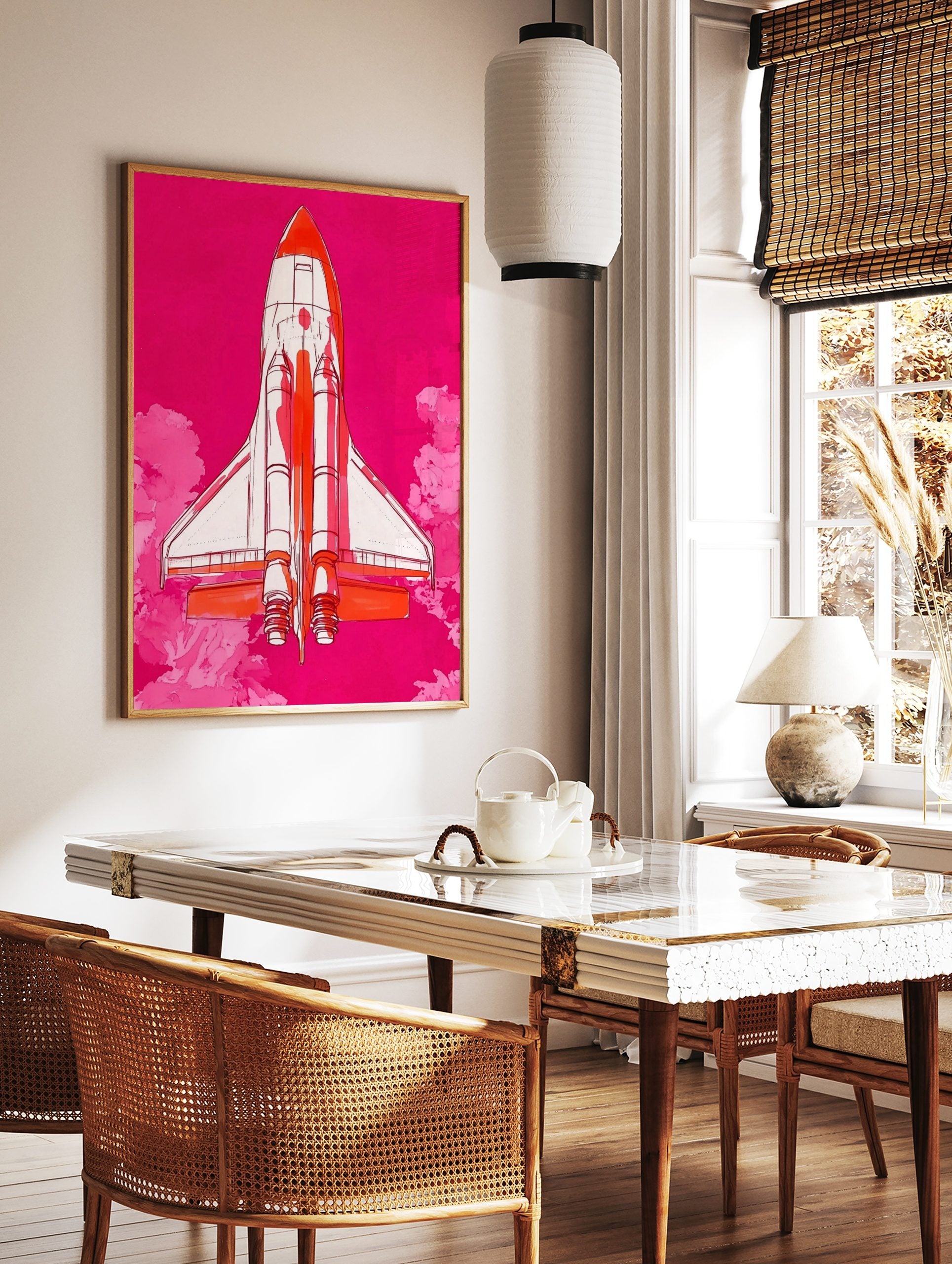 Illustrative Space Shuttle rocket in white and orange against a vibrant pink sky with pink clouds, in a styled room mockup