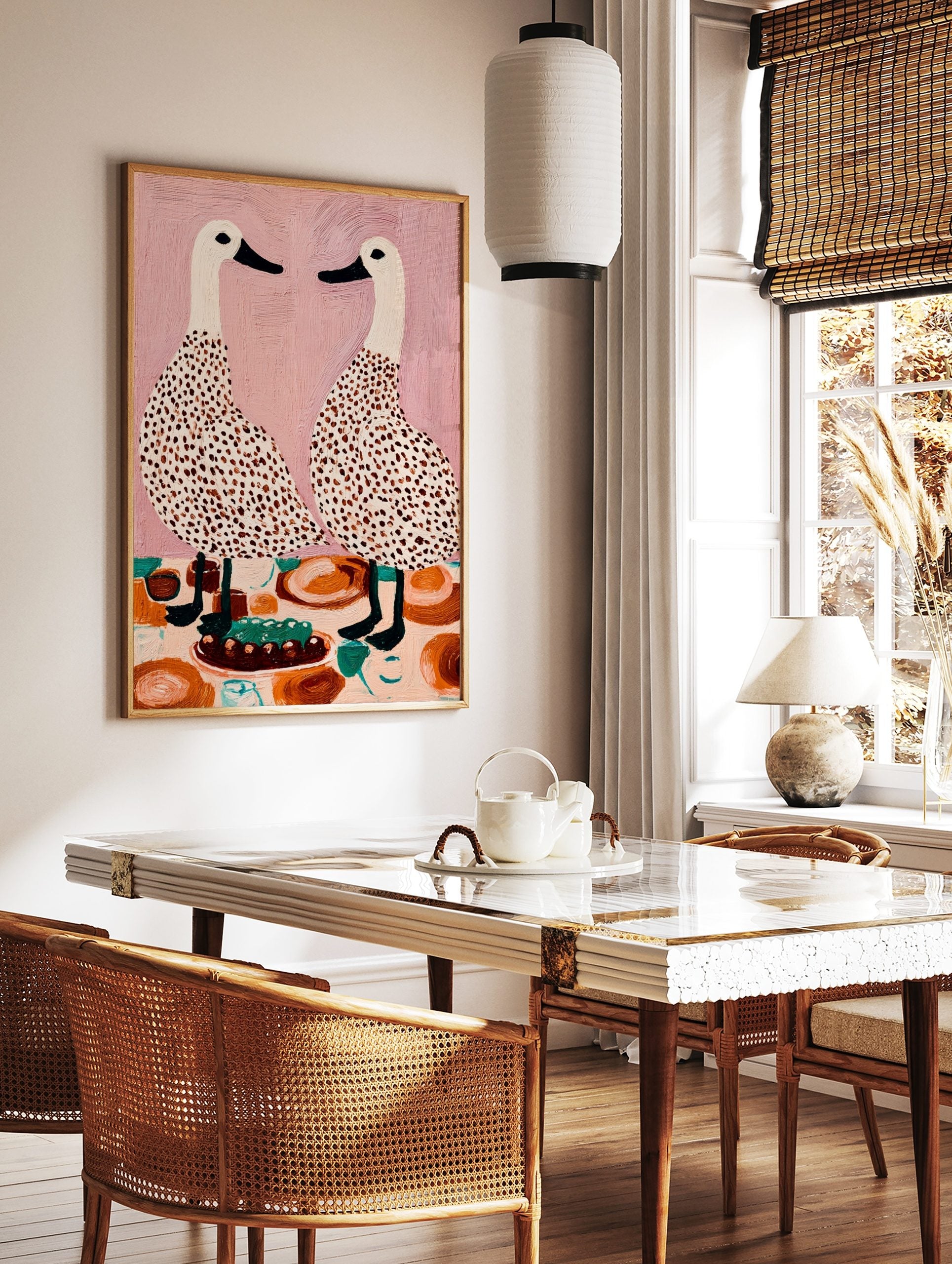Illustrative wall art of two speckled white ducks facing each other at a dining table with a cake, in a styled room mockup