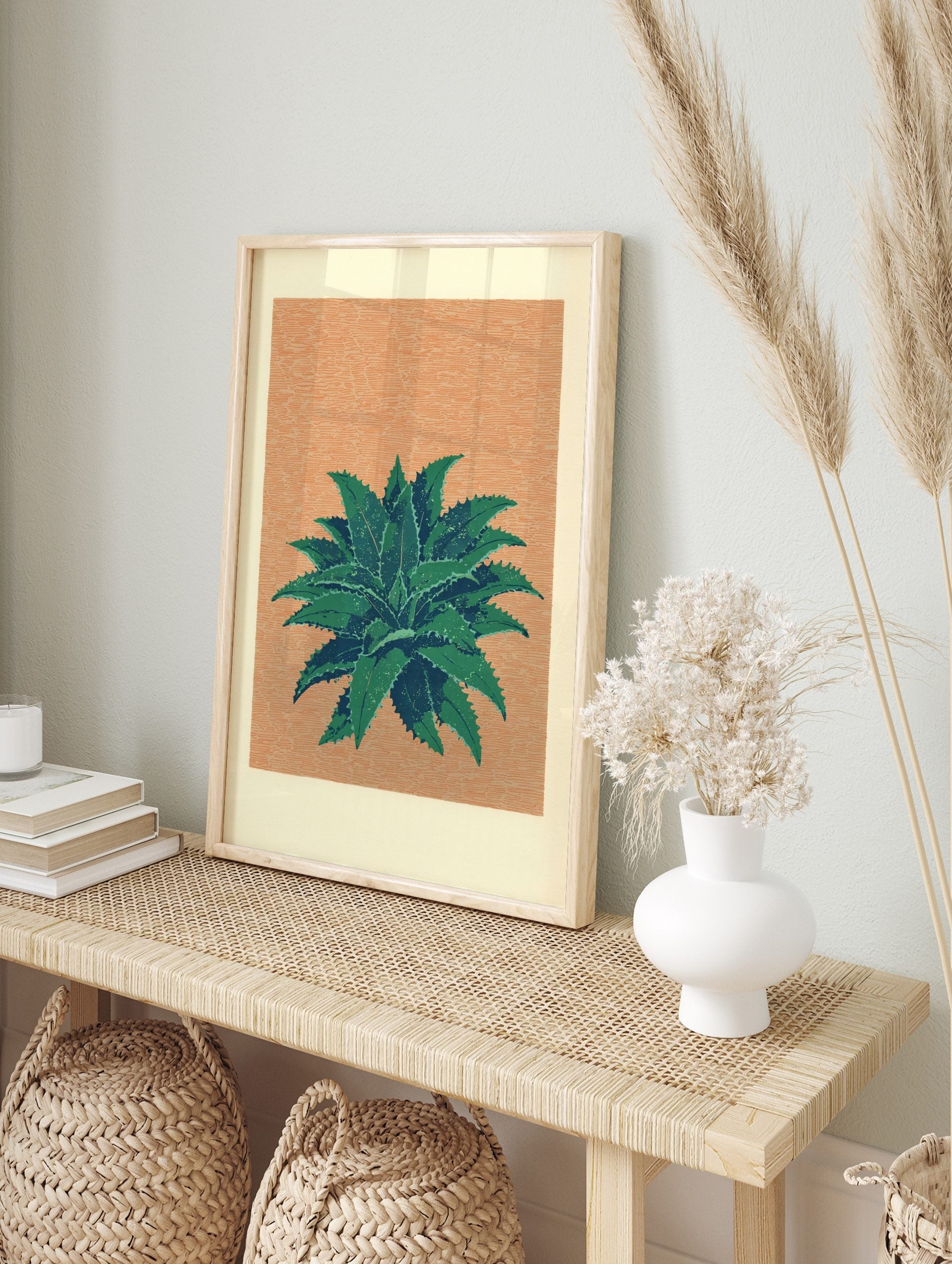 Illustrative green succulent plant with spiky leaves on a textured peach-orange background, in an alternate framed mockup