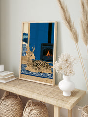 Spotted deer illustration on blue rug with fireplace and snowy mountain window view in a flat, in an alternate framed mockup