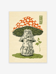 Japanese woodblock print of a red and white spotted mushroom with green gills and a stem on grass