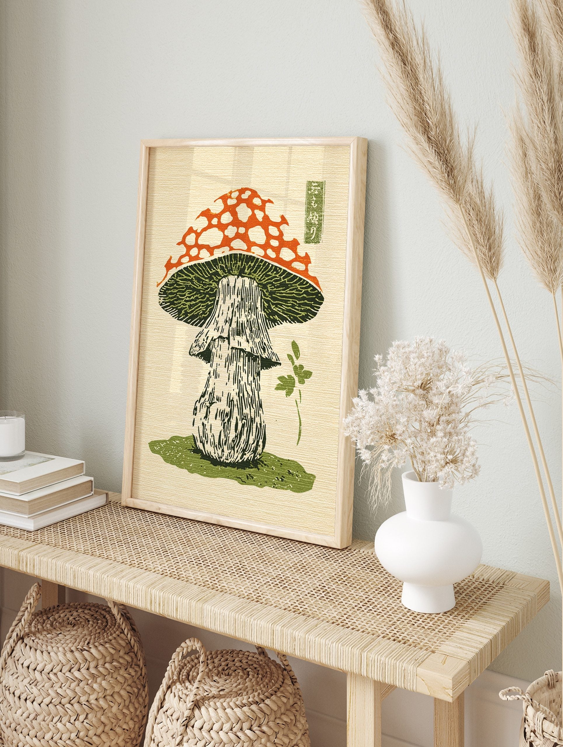 Japanese woodblock print of a red and white spotted mushroom with green gills and a stem on, in an alternate framed mockup