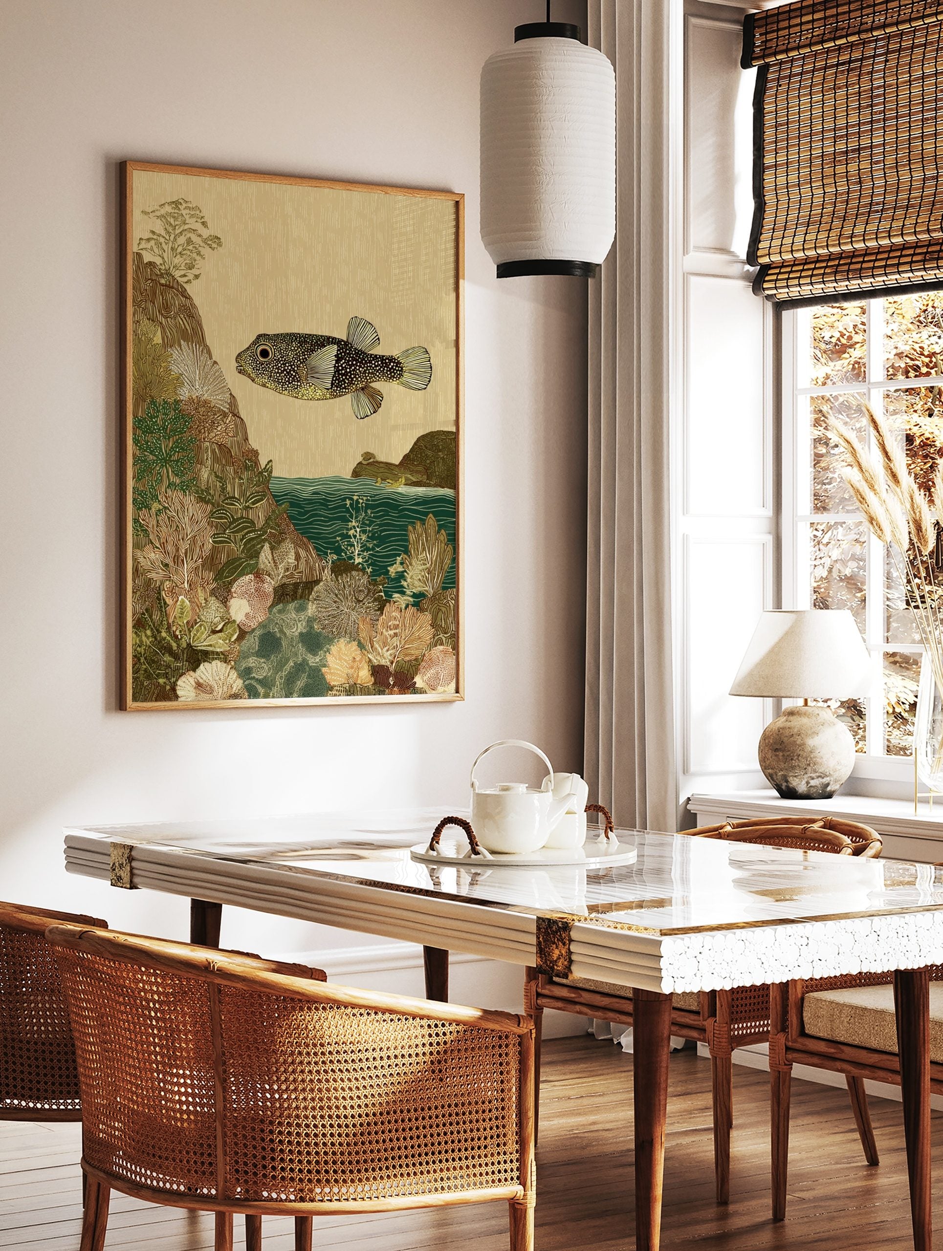 Illustrative art print of a spotted pufferfish swimming over detailed coral and rocky seabed in, in a styled room mockup