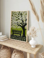 Illustrative spring blossom tree with white flowers, green leaves, and park bench on grass, in an alternate framed mockup