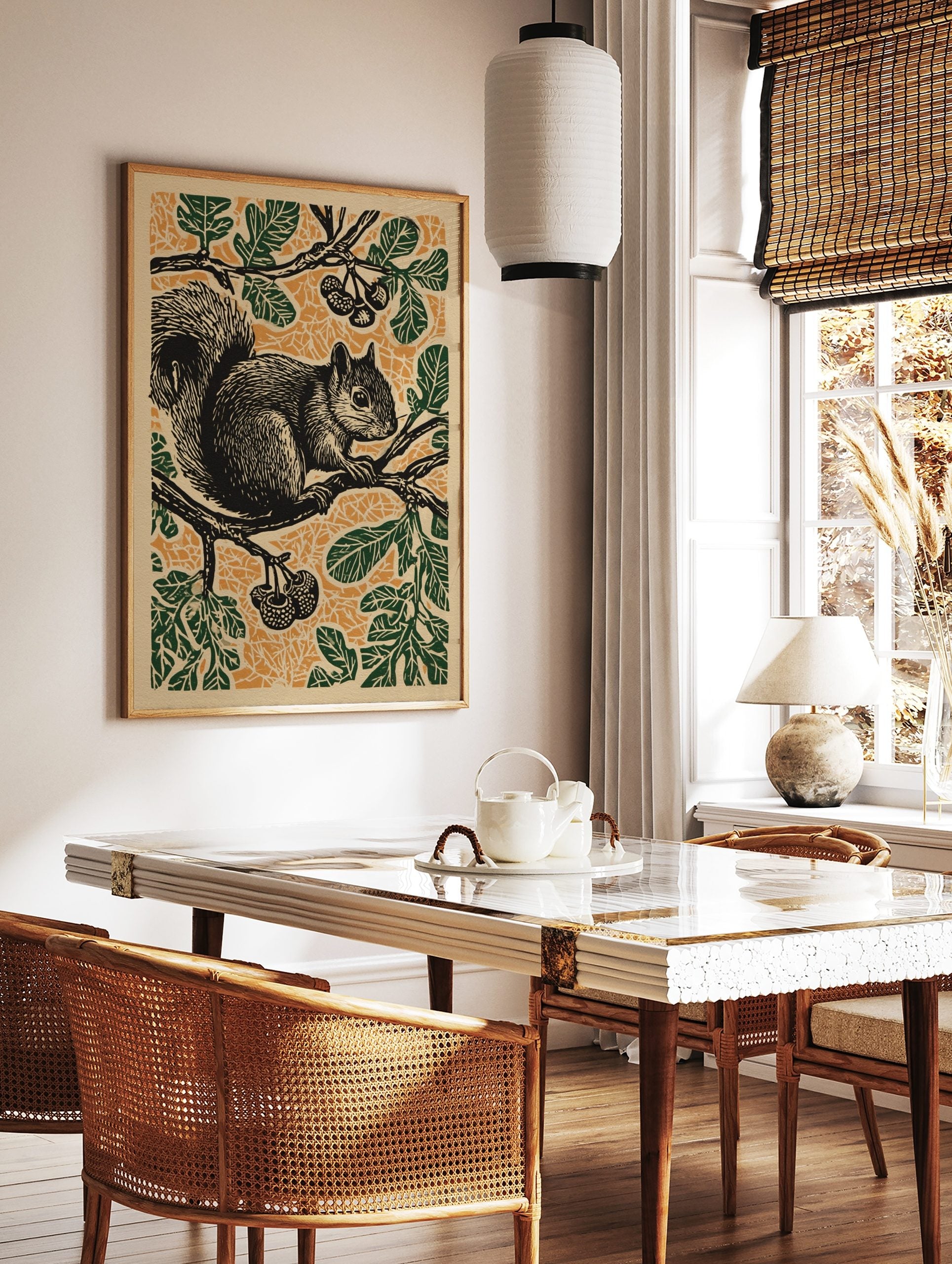 Black squirrel on a tree branch with green leaves and orange patterned background in linocut style, in a styled room mockup