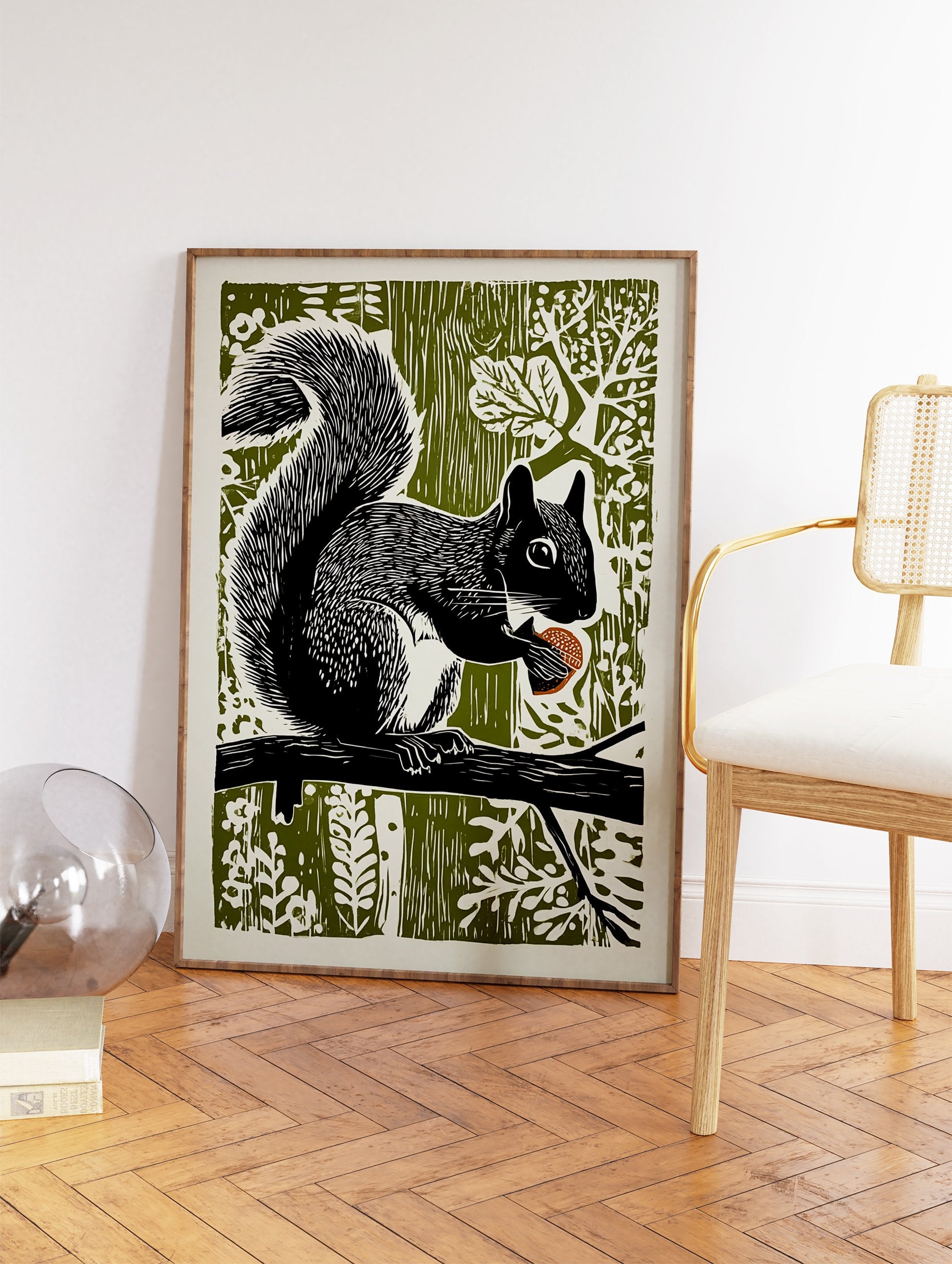 Black and white linocut art print of a squirrel holding an acorn on a branch against an olive green forest background. - Image 2