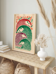 Illustrative print of four stacked badger-like animals in red, green, and purple, with foliage, in an alternate framed mockup