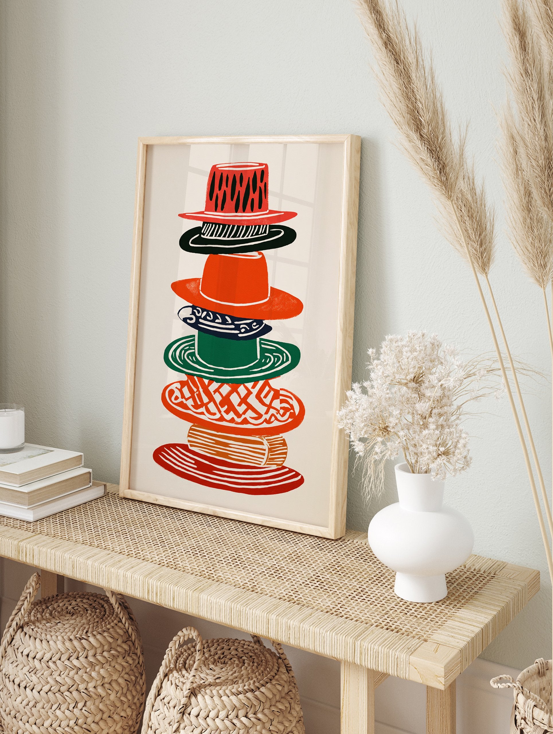 Multi-color stacked hats wall art illustration with various patterns in red, green, black, and orange on a cream background. - Image 3