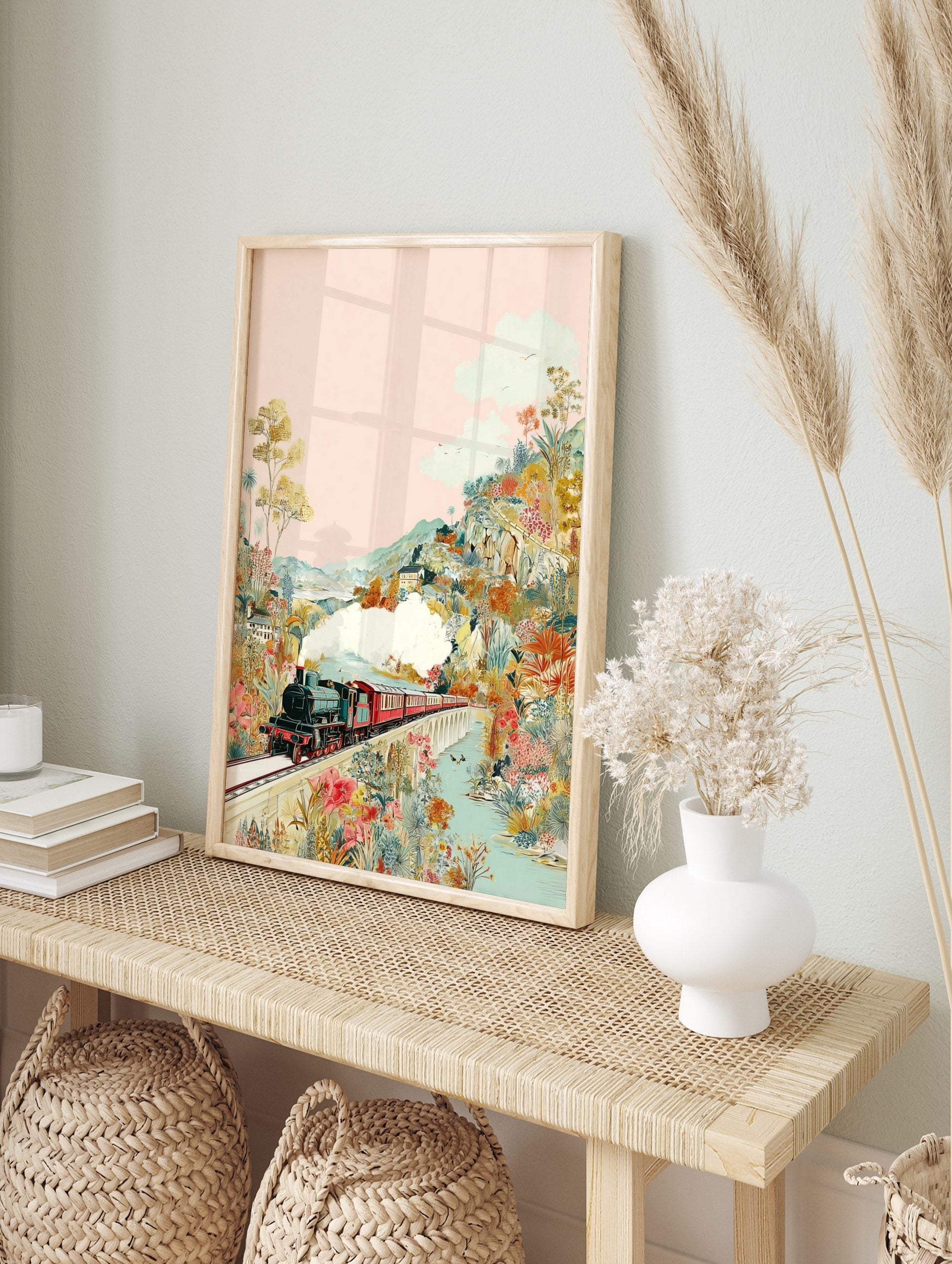 Colourful illustrative print of a steam train on a bridge, surrounded by lush, vibrant, in an alternate framed mockup
