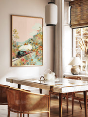 Colourful illustrative print of a steam train on a bridge, surrounded by lush, vibrant flowers and, in a styled room mockup