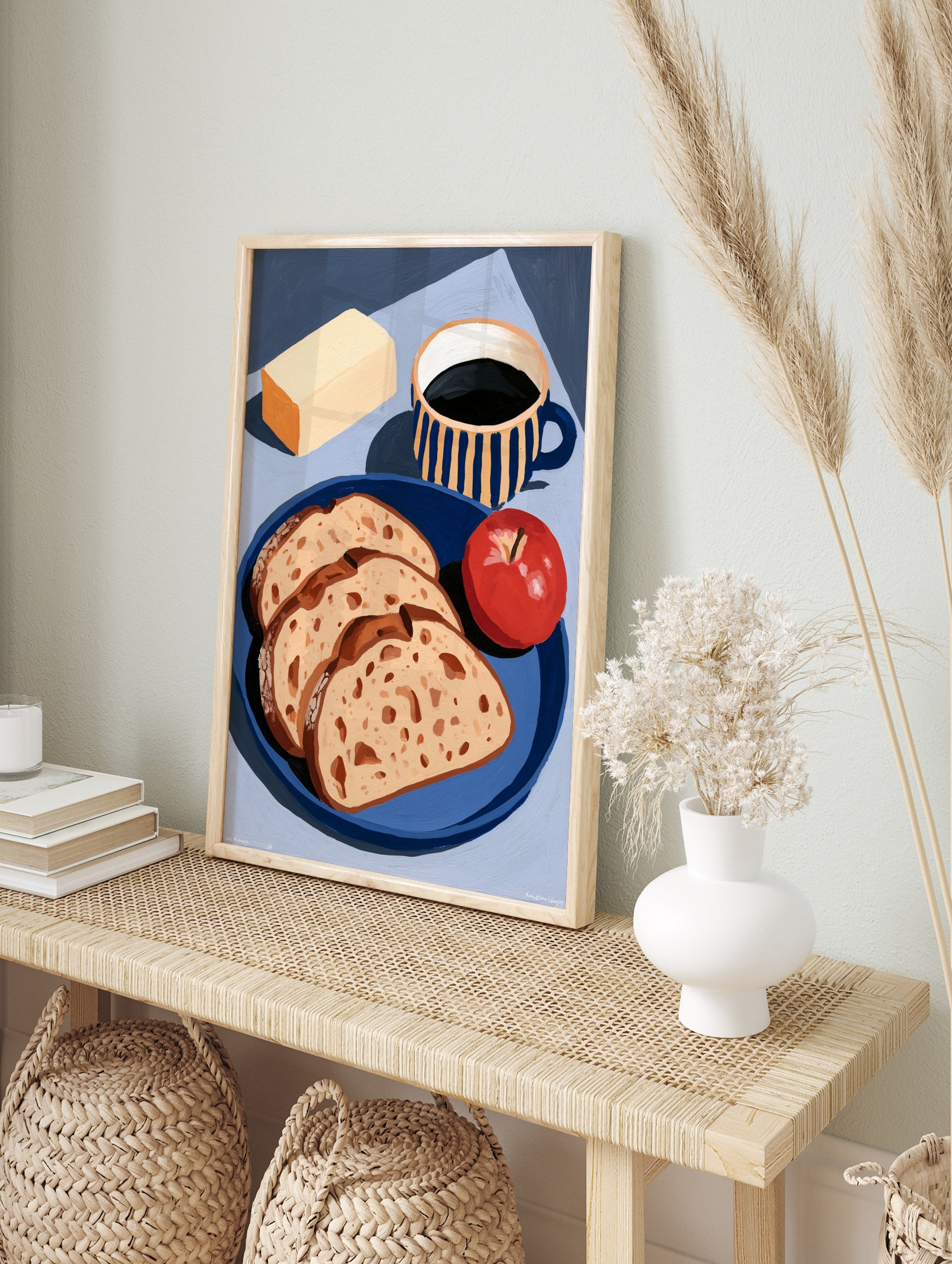 Still life art print of bread slices, an apple, butter, and a striped coffee mug on a blue, in an alternate framed mockup