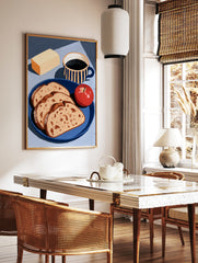 Still life art print of bread slices, an apple, butter, and a striped coffee mug on a blue plate, in a styled room mockup