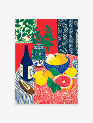 Still life fruit poster with lemons, grapefruit, limes, blue bottle, and vase with green leaves on a patterned red and blue tablecloth.