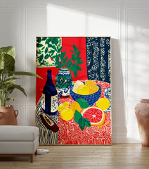 Still life fruit poster with lemons, grapefruit, limes, blue bottle, and vase with green leaves on a patterned red and blue tablecloth. - Image 3