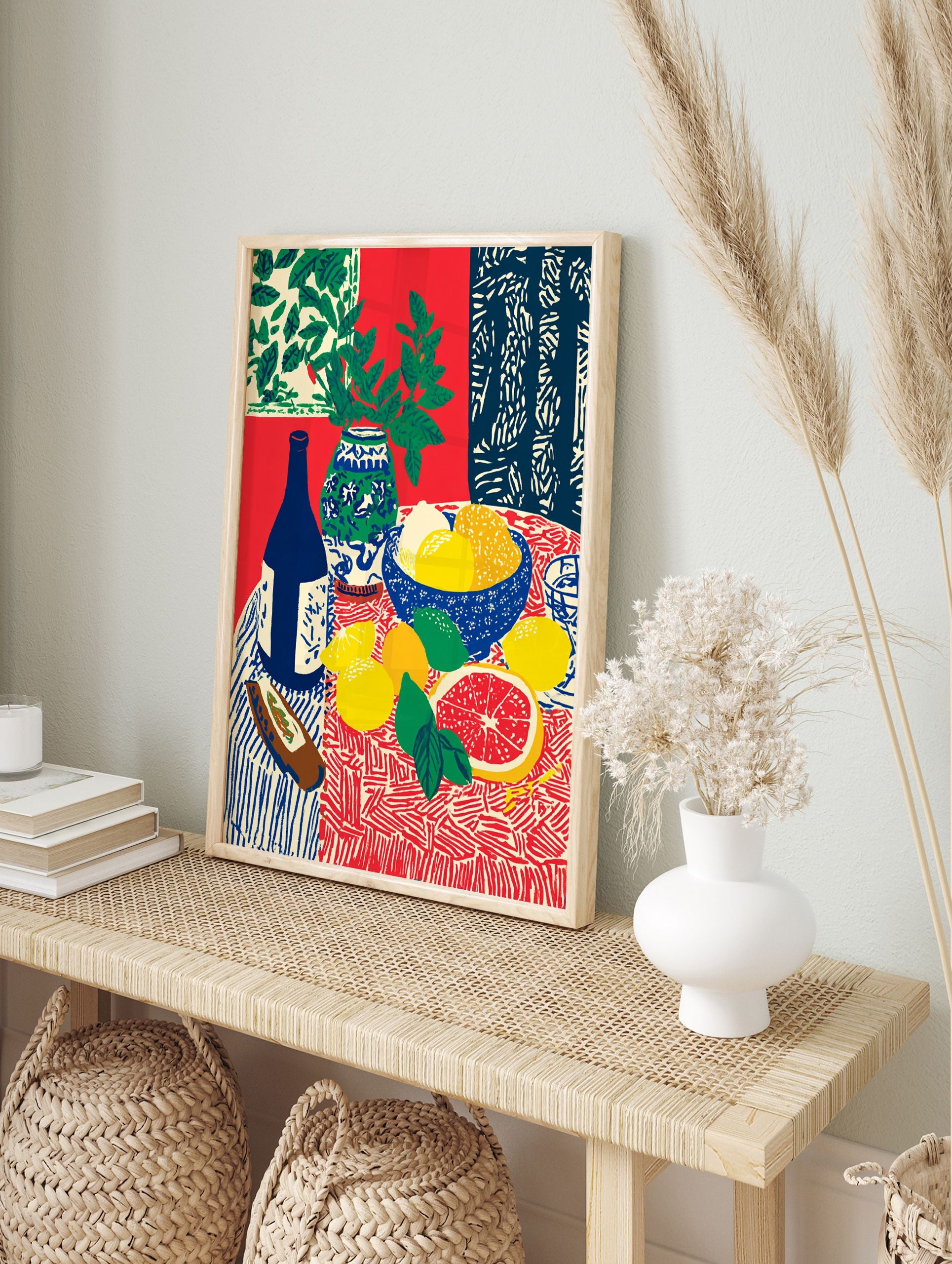 Still life fruit poster with lemons, grapefruit, limes, blue bottle, and vase with green leaves on a patterned red and blue tablecloth. - Image 4
