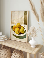 Painterly still life of yellow lemons with green leaves on a white plate against a light, in an alternate framed mockup