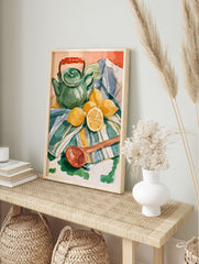 Watercolor still life illustration of a green teapot, lemons, and a wooden spoon on a striped, in an alternate framed mockup