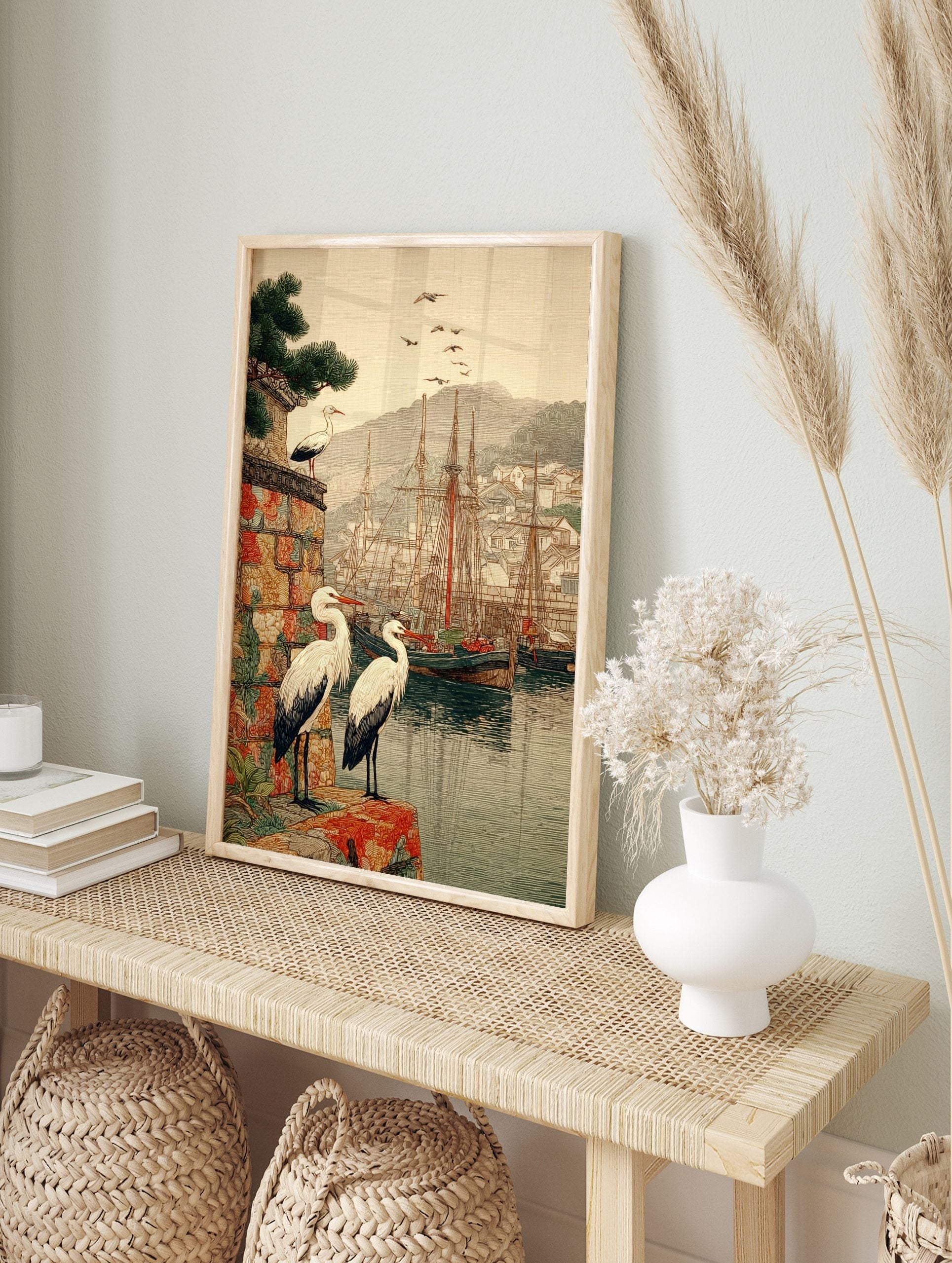 Japanese woodblock style print of white storks overlooking a harbour with ships and a, in an alternate framed mockup