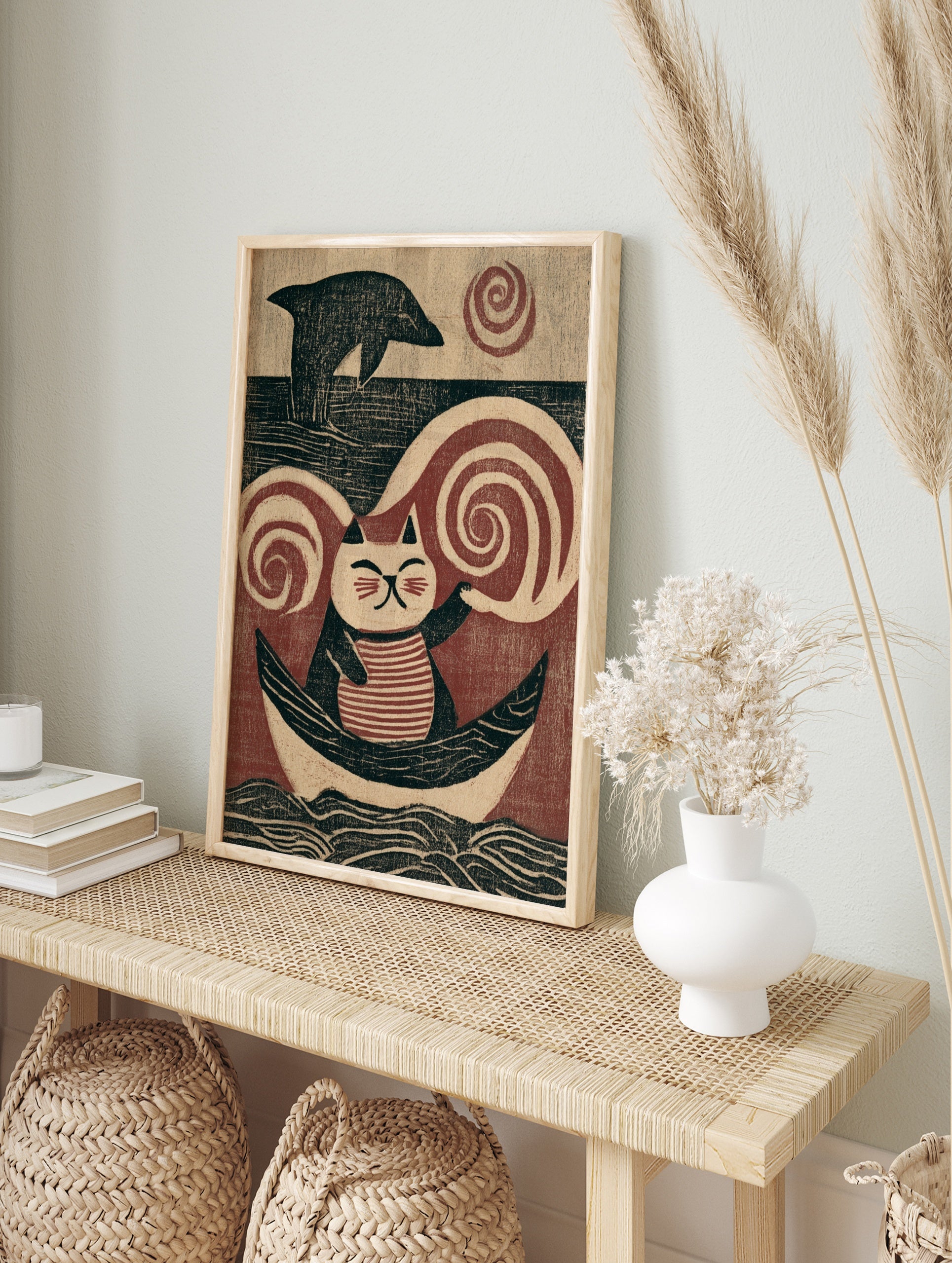 Illustrative art print of a striped cat sitting in a boat with a dolphin and swirling wind, in an alternate framed mockup