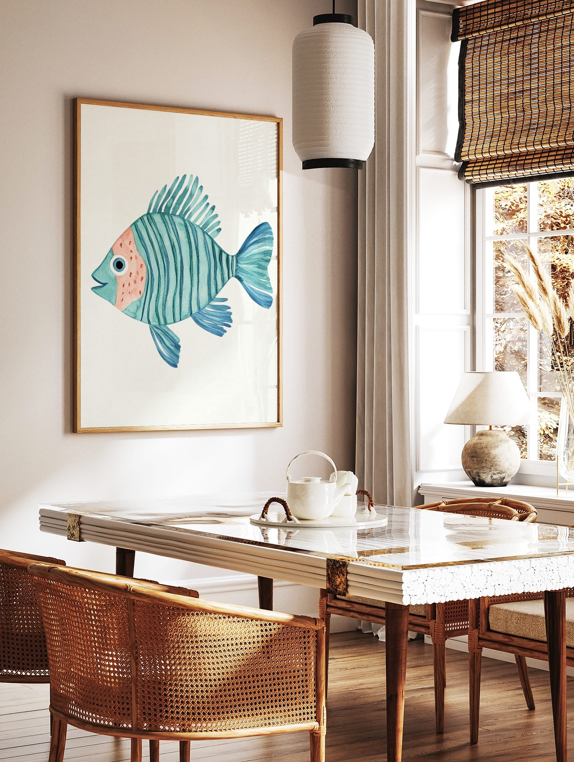Watercolour illustration of a teal striped fish with peach face and blue fins on a white background, in a styled room mockup