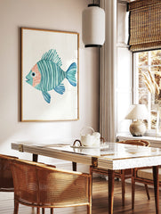 Watercolour illustration of a teal striped fish with peach face and blue fins on a white background, in a styled room mockup