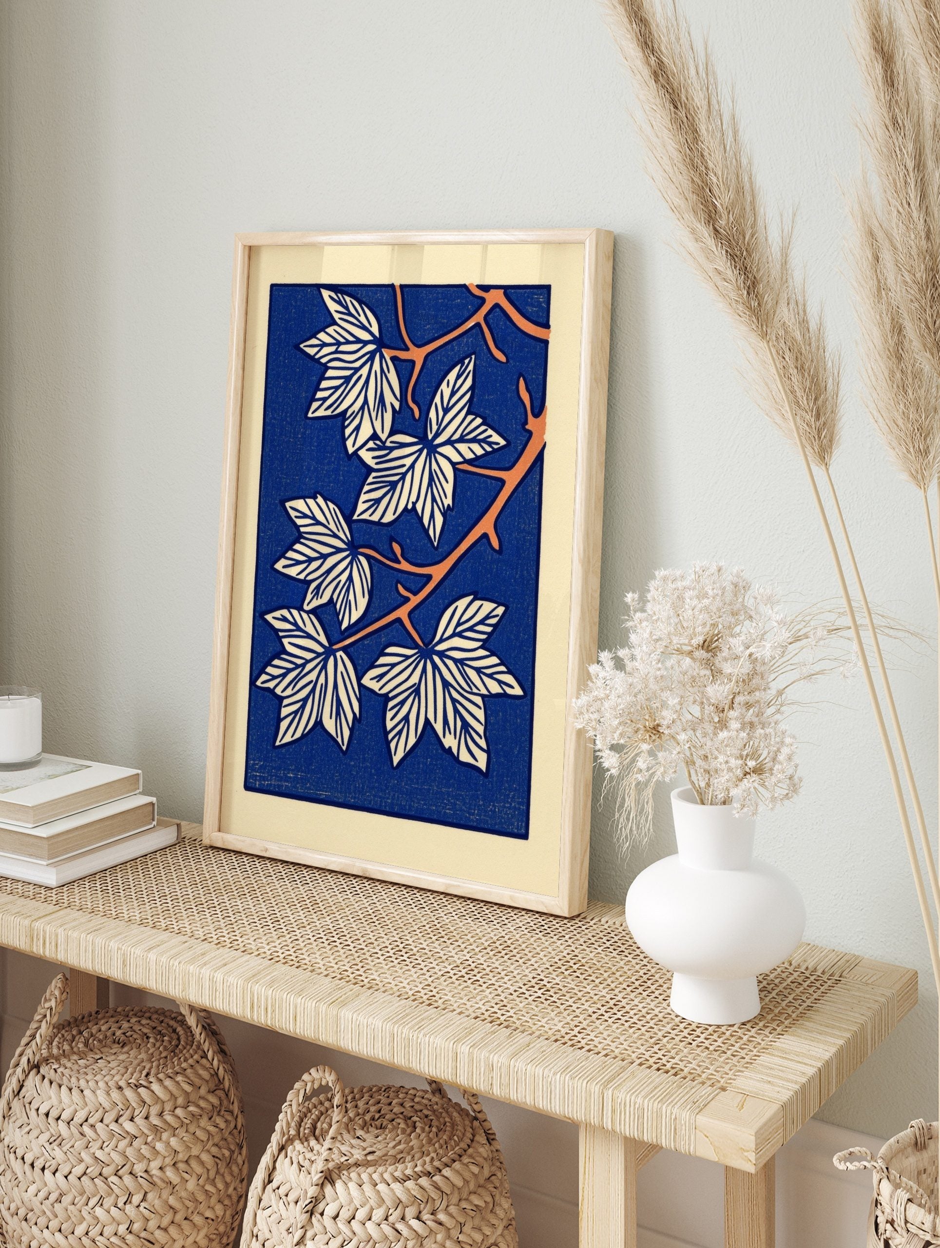 Stylised botanical leaf illustration art print with white leaves, orange branches, and a deep, in an alternate framed mockup