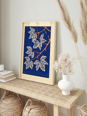 Stylised botanical leaf illustration art print with white leaves, orange branches, and a deep, in an alternate framed mockup