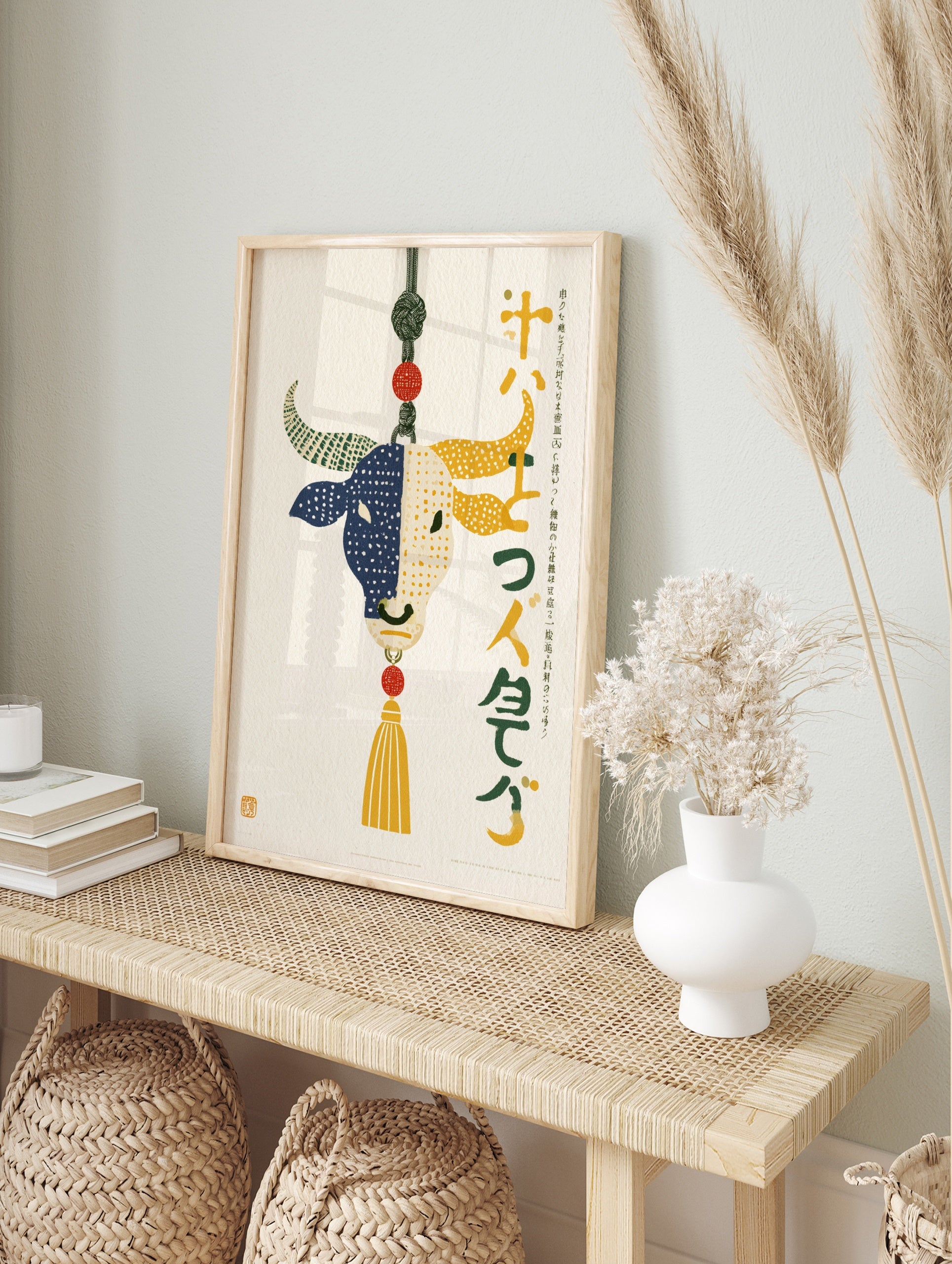 Stylised bull illustration with split blue and yellow dotted design, decorative knot, and, in an alternate framed mockup