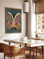 Stylised butterfly woodblock print with deep purple, red, and brown wings on a textured dark blue, in a styled room mockup