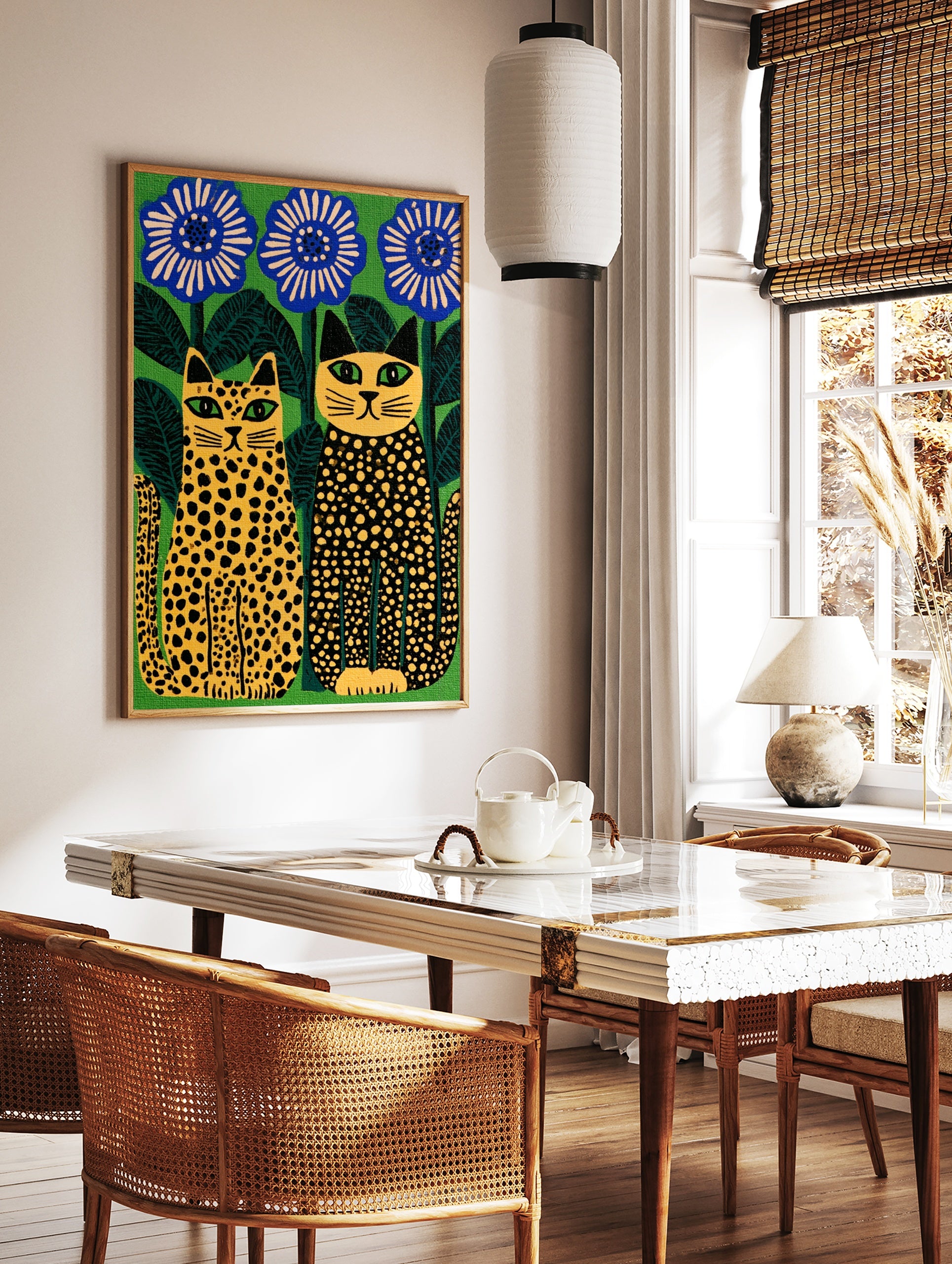 Stylised illustration of two spotted cats sitting beside large blue flowers against a vibrant green, in a styled room mockup