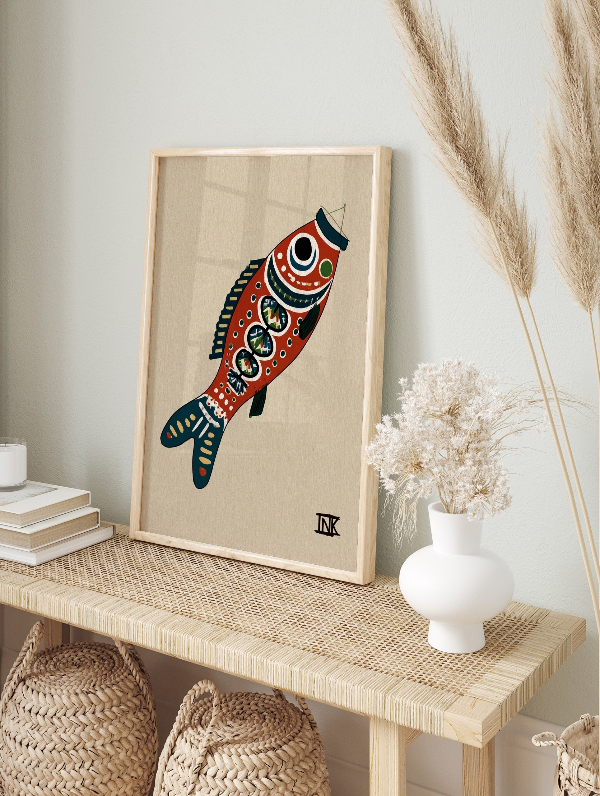 Stylised red fish illustrative art print with blue details on a tan background, in an alternate framed mockup