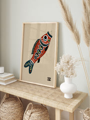 Stylised red fish illustrative art print with blue details on a tan background, in an alternate framed mockup