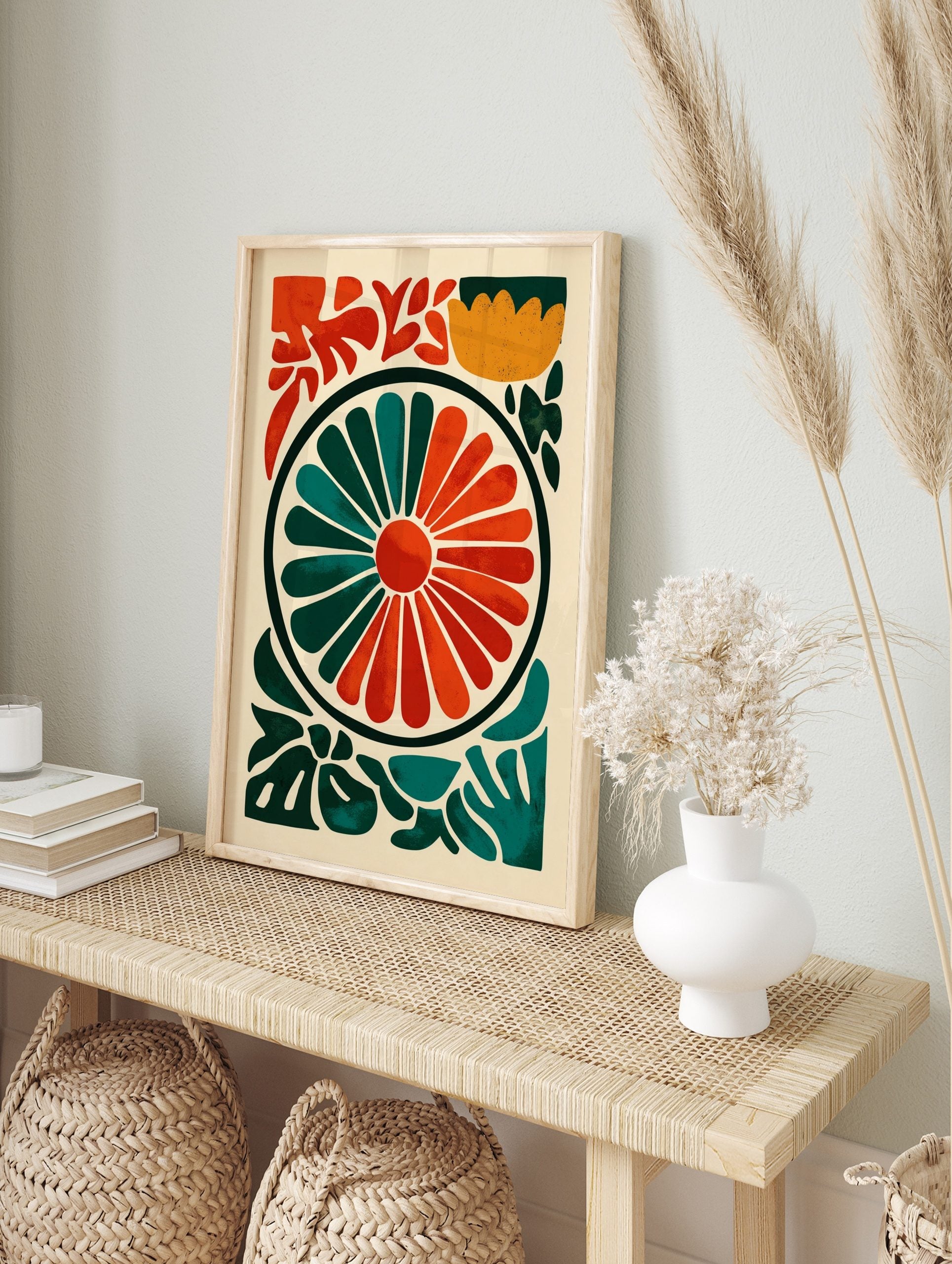 Abstract floral wheel art print with radiating orange and teal segments, surrounded by green, in an alternate framed mockup