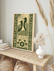 Art Nouveau style wall art print with two dark green stylised birds, leafy bush, decorative, in an alternate framed mockup